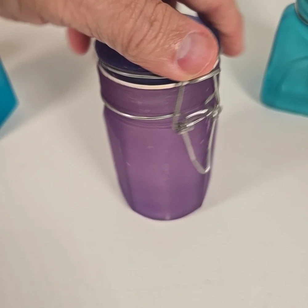 Set Of Four Colored‎ Glass Cannisters With Locking Tops Very Good Condition